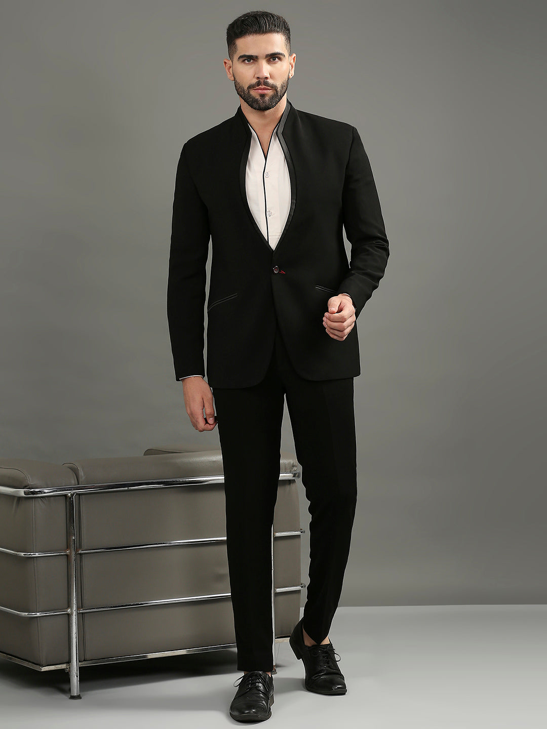 Featuring a black tuxedo featuring a high neck & satin accents, paired with black formal pants - perfect for black-tie events or gala dinners.
