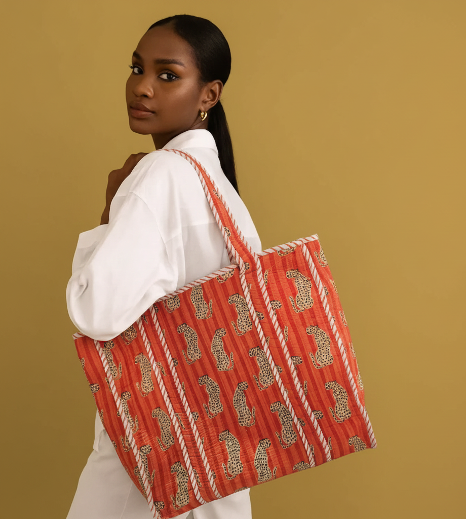 Woman holding a red block print bag against from Jaipur