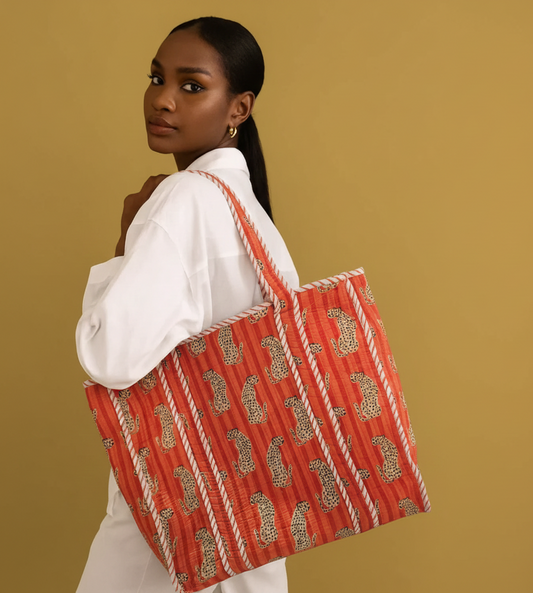 Woman holding a red block print bag against from Jaipur
